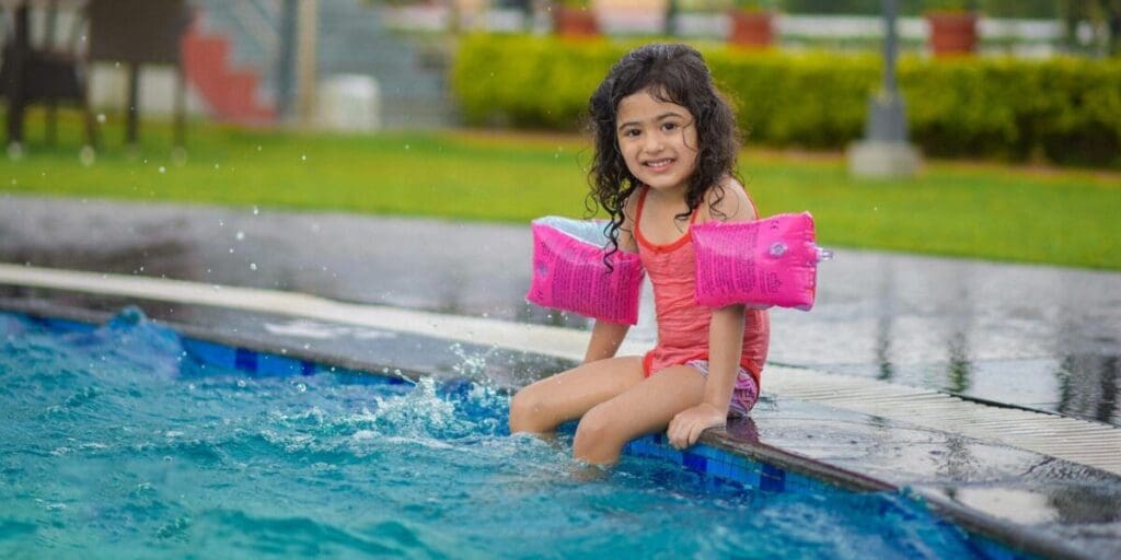 Girl Splashing Clean Clear Swimming Pool Water